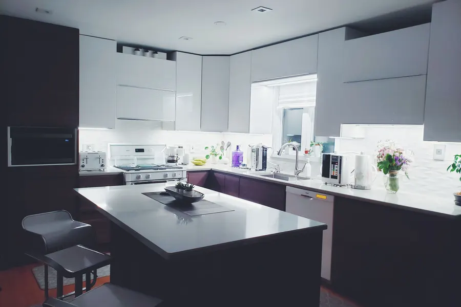 Open-plan kitchen with a full-height pantry wall — main photo