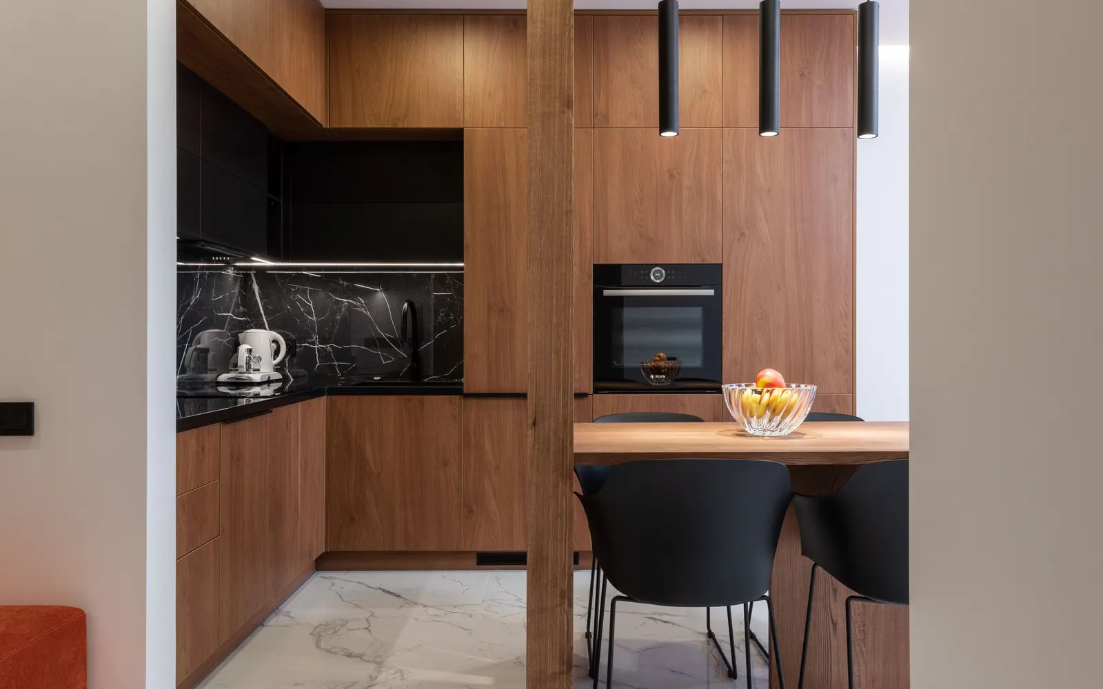 Compact kitchen with hidden appliances — before