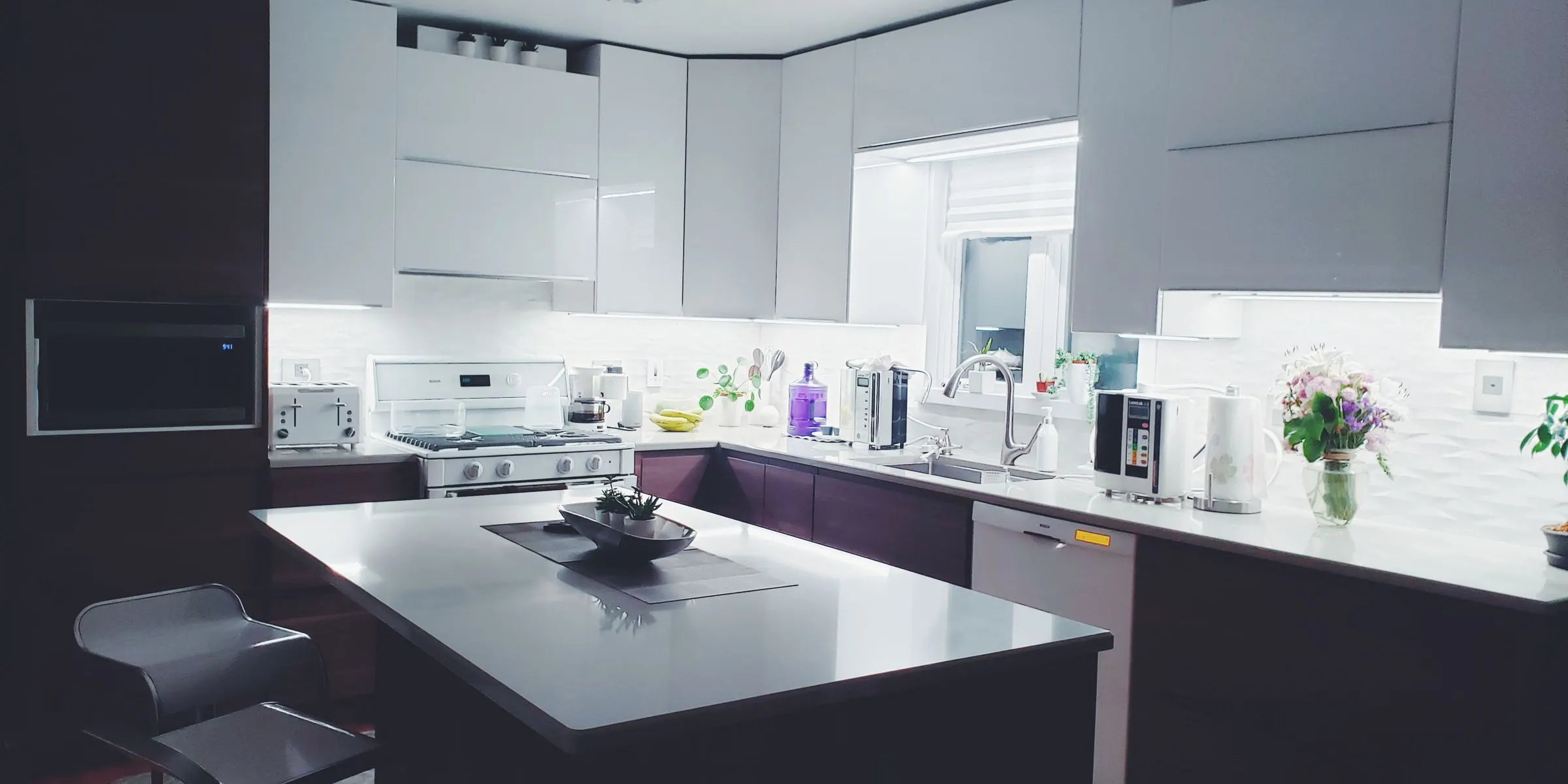 Open-plan kitchen with a full-height pantry wall — main photo